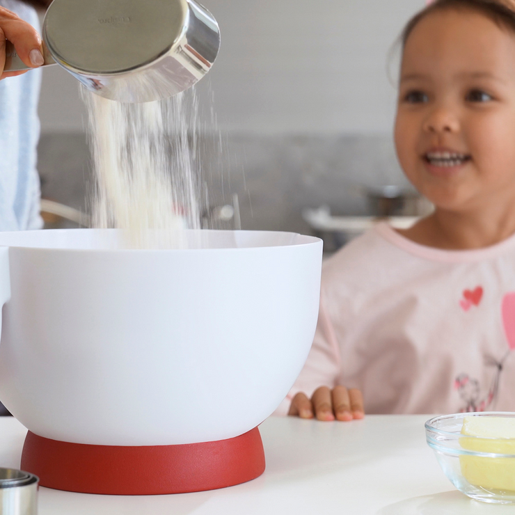 Cuisipro Batter bowl with flour being added and excited little girl watching batter being made.